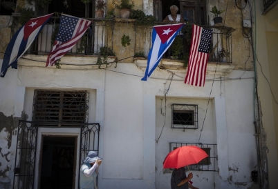 The US and Cuban flags over a balcony in Havana, Cuba