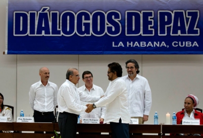 Colombian negotiators shake hands in Havana over FARC talks.