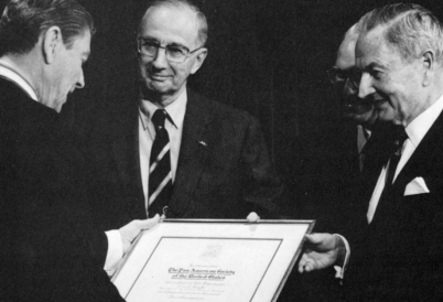 U.S. President Ronald Reagan (L), receiving the 1987 Gold Insigne from AS/COA President Emeritus George W. Landau and David Rockefeller.