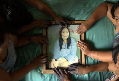 Multiple people holding a frame