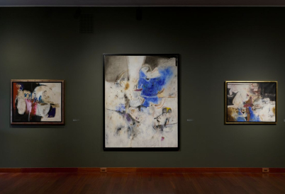 Three abstract artworks on a wall