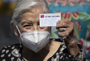 A Chilean woman shows her vaccination card. (AP)