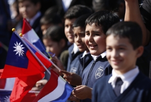 Paraguayan children wave Taiwanese flags. (AP)