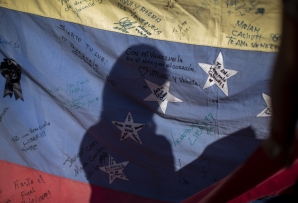 Silhouette on a Venezuelan flag at a voting center in Madrid, Spain. (AP)