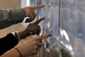 Voters check lists in Colombia.