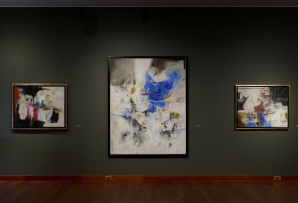 Three abstract artworks on a wall
