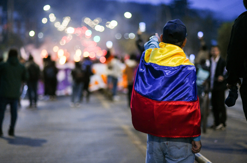 Colombian protestor wearing flag