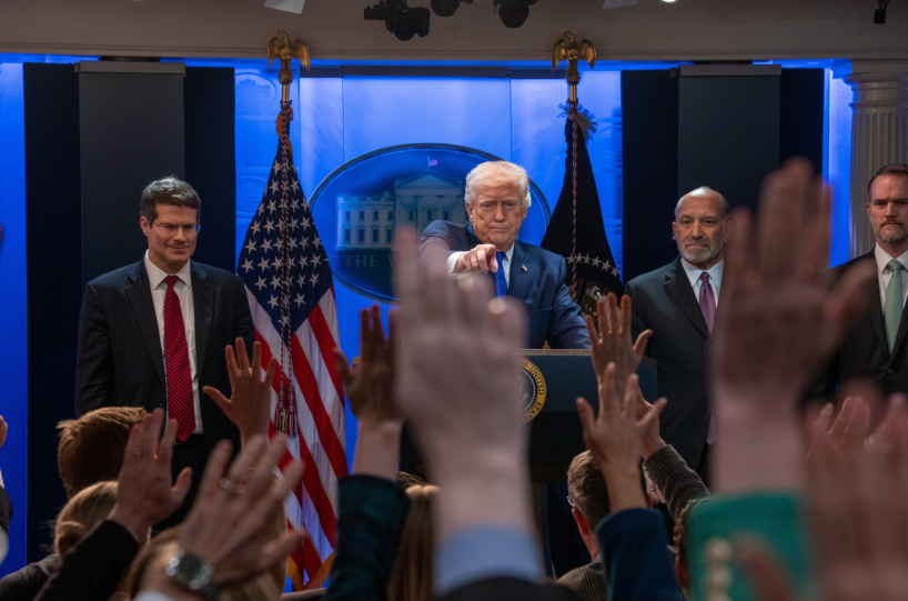 Trump pointing at a press conference.