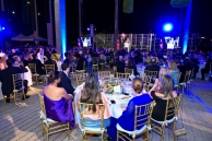 People seating around dining tables during the ceremony