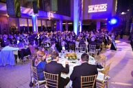 People seating around dining tables during the ceremony