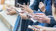 People holding cell phones (AdobeStock)