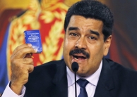 Nicolas Maduro holding a tiny constitution