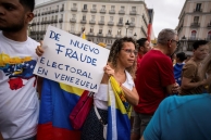 Protester in Madrid holding a sign 